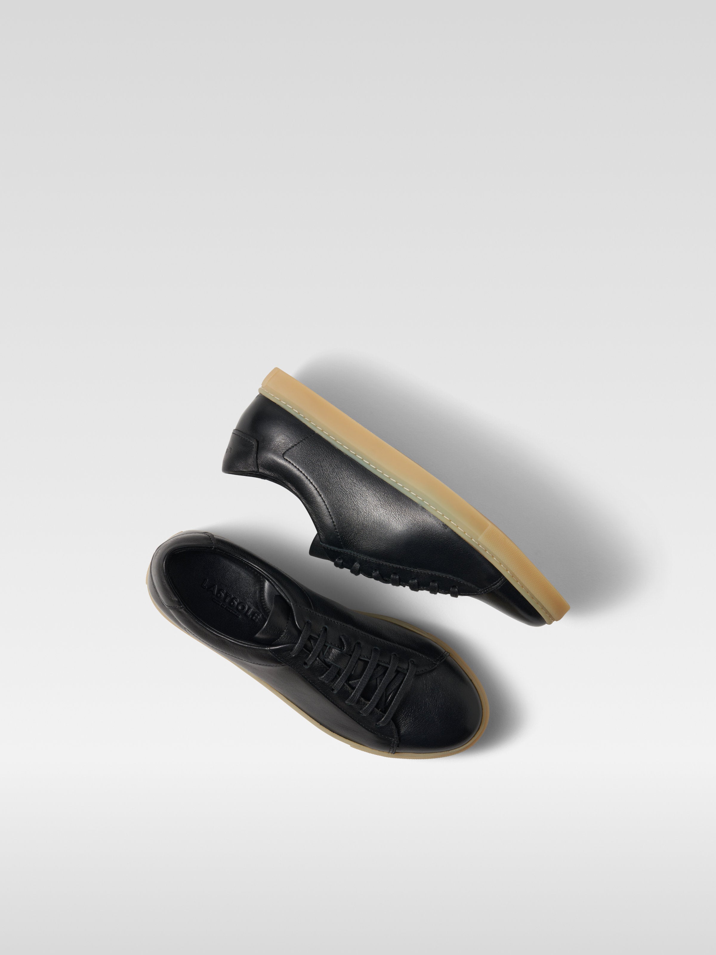 Black leather sneakers in gum sole for men