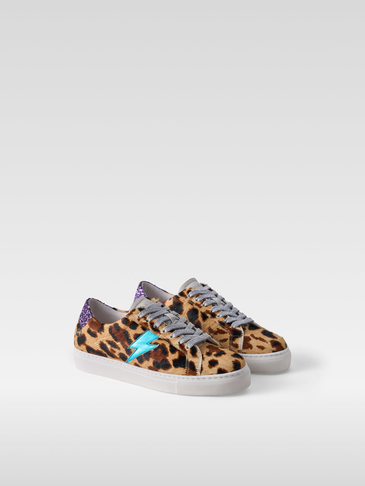Pulse jaguar pony hair sneakers with turquoise lightning bolt for women, three-quarter view